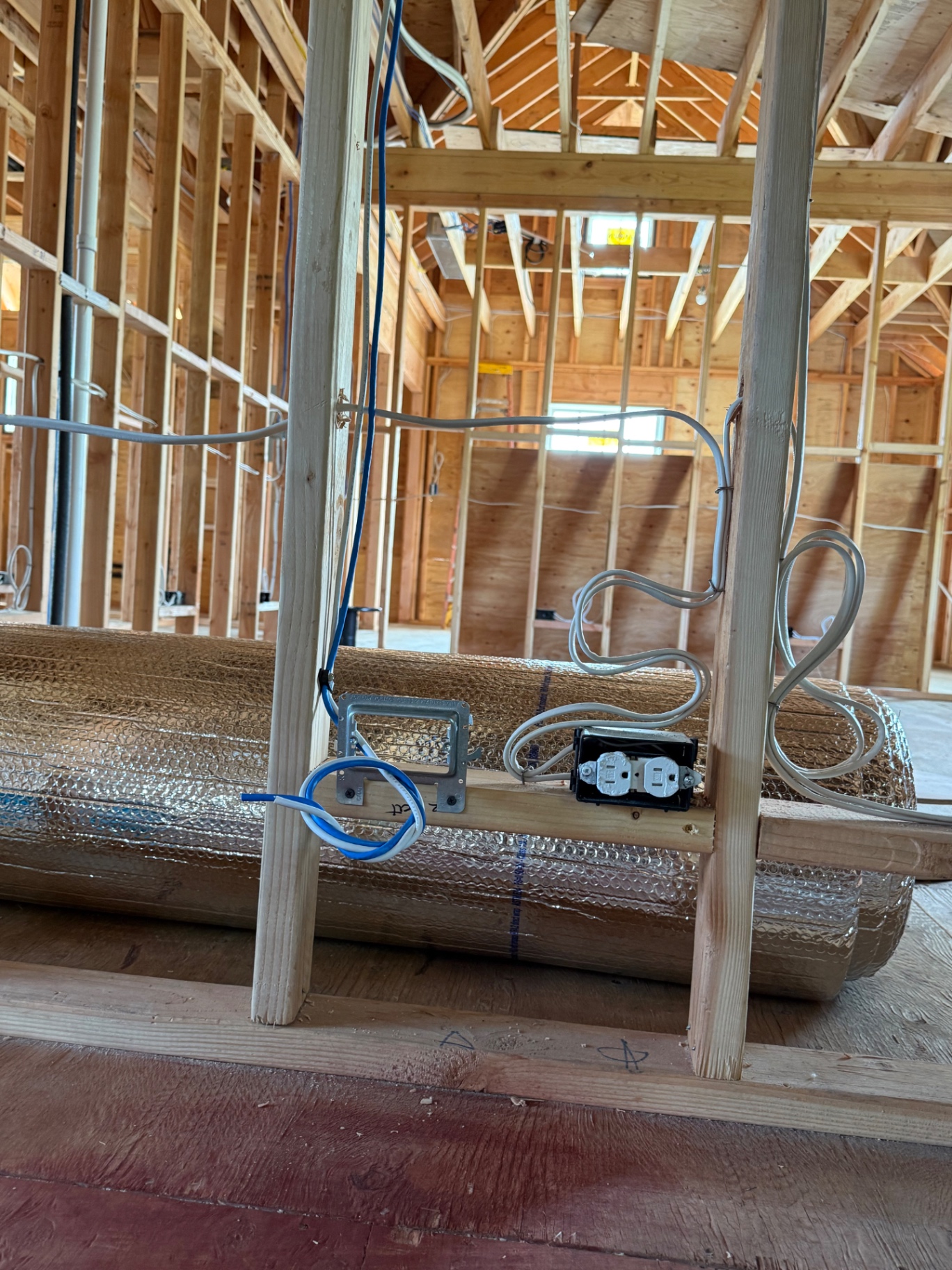 Structured wiring data drop mounted to framing next to a power outlet