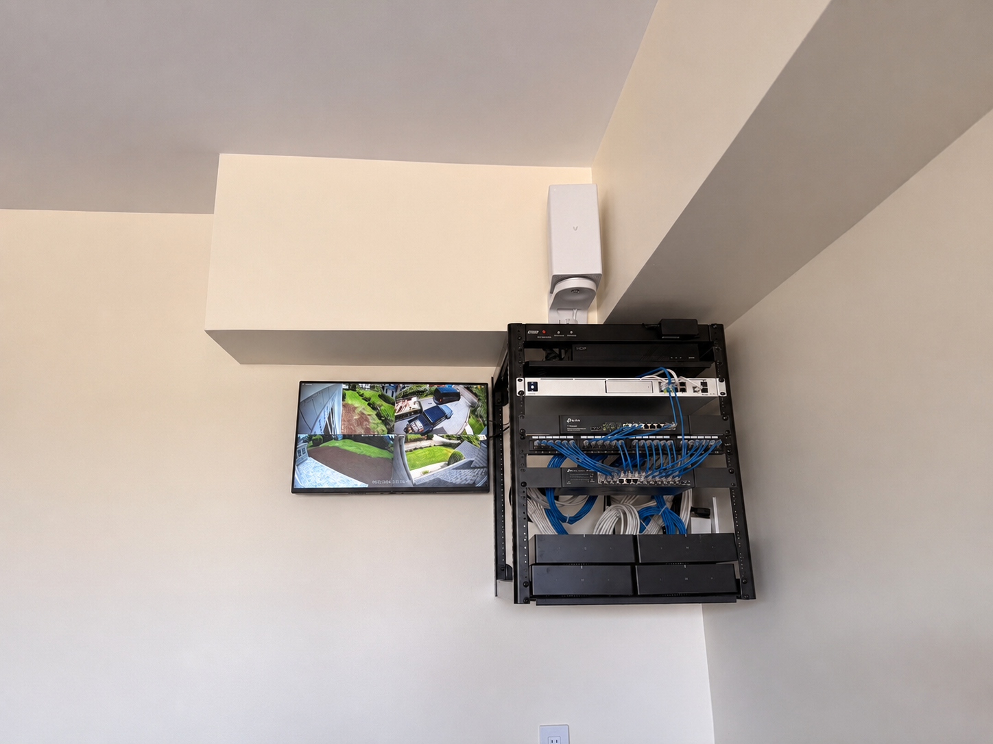 Wall mounted network rack with NVR, switch and organized Cat6 cabling by JR Make It Solutions