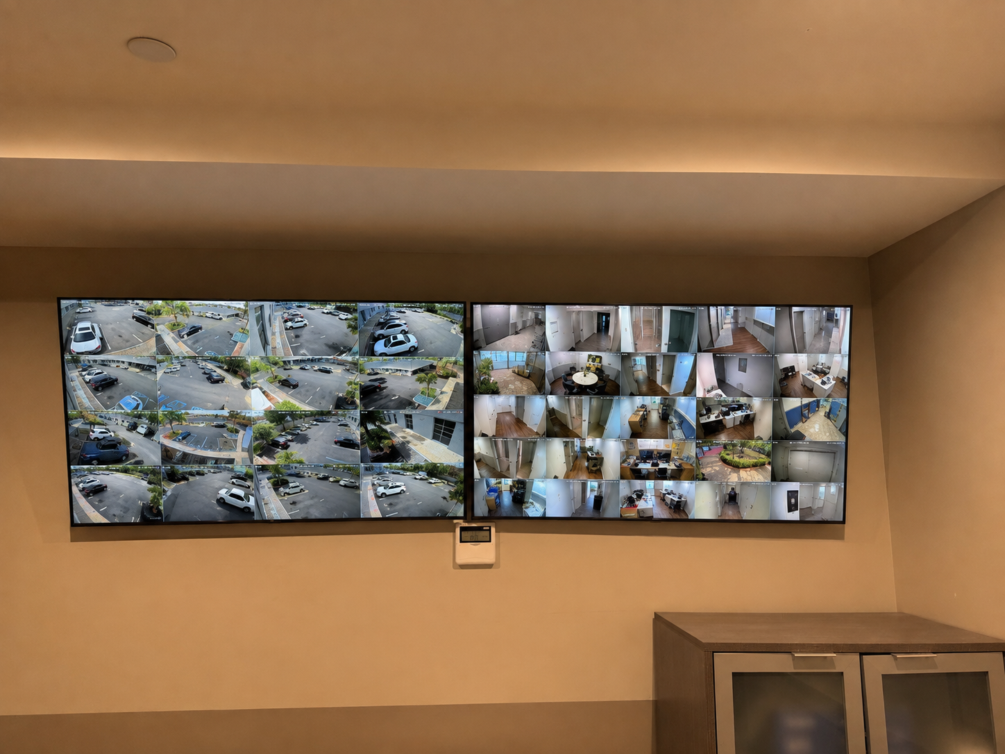 Dual monitor video wall displaying multi-camera commercial CCTV feeds