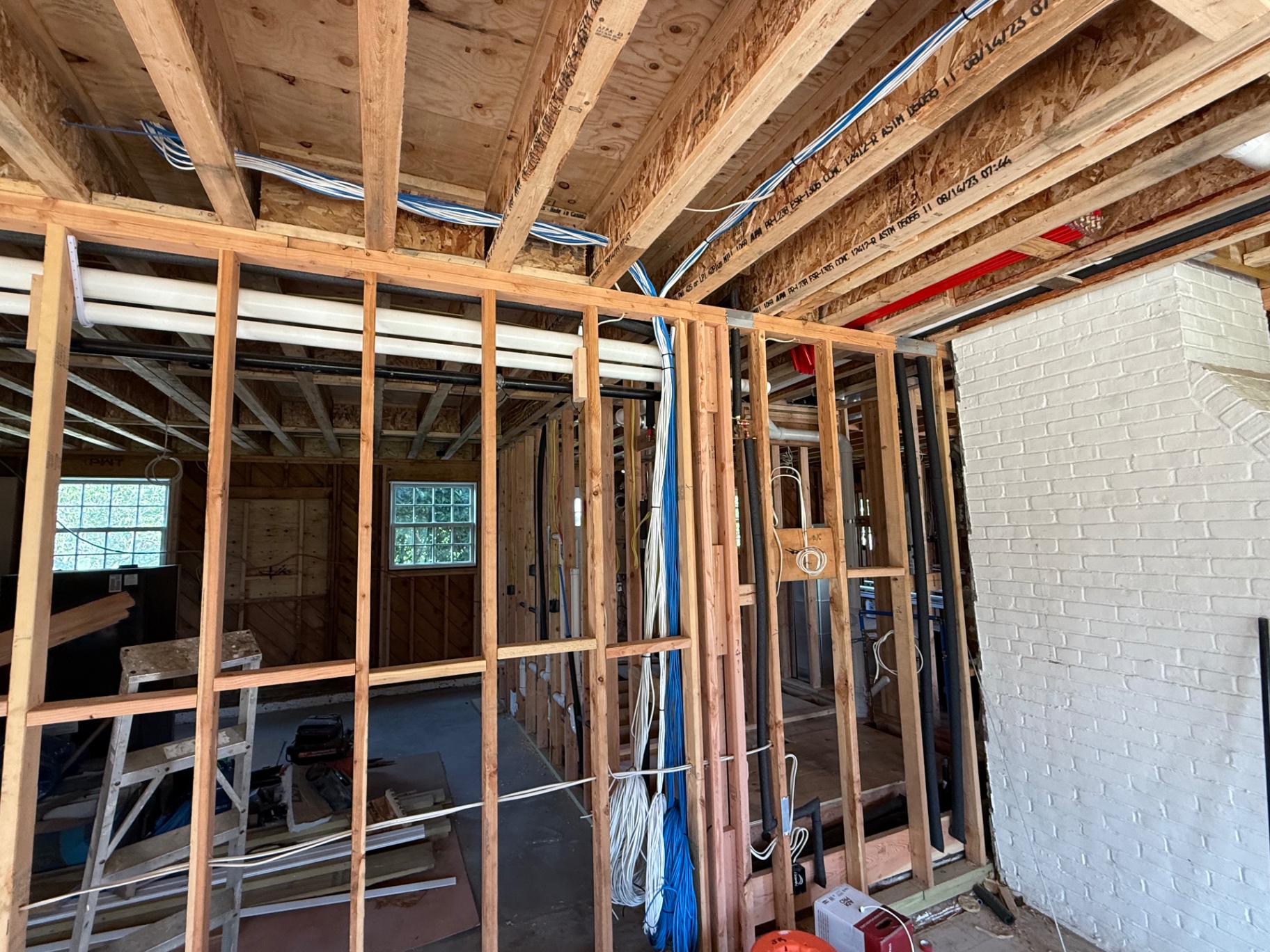Low voltage cable pathways routed through open framing on a residential job site